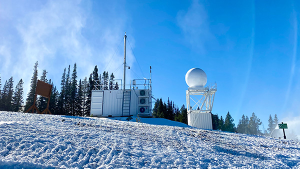 Photo taken at Mount Crested Butte, Colorado, during the ARM SAIL Campaign. Shown on the left (with stack) is the Aerosol Observing System (AOS).  (Image credit: Janek Uin, Brookhaven National Laboratory).