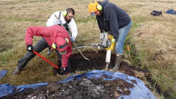 Opening a pit to observe and sample the soil profile of a low-centered ice-wedge polygon on the Arctic Coastal Plain of Alaska. (Image credit: Julie Jastrow, Argonne National Laboratory)